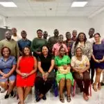 Razaki Omia (striped T-shirt), the CEO, Omia Agribusiness at the Acumen Community Gathering in Kampala